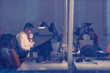 Image showing businessman working using a laptop in startup office