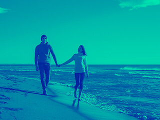 Image showing Loving young couple on a beach at autumn sunny day