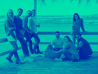 Image showing Group of friends having fun on autumn day at beach