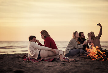 Image showing Friends having fun at beach on autumn day