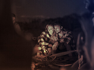 Image showing Couple enjoying with friends at night on the beach