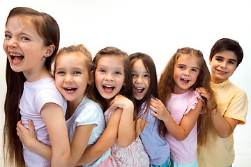 Image showing The portrait of cute little boy and girls in stylish clothes looking at camera at studio