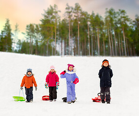 Image showing happy little kids with sleds in winter