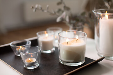 Image showing burning fragrance candles on table at cozy home