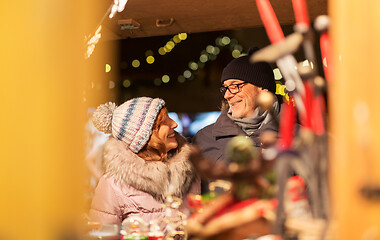 Image showing senior couple at christmas market souvenir shop