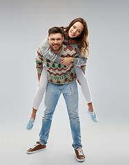 Image showing happy couple at christmas ugly sweater party