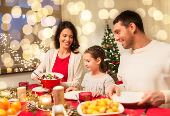 Image showing happy family having christmas dinner at home