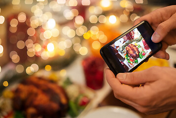 Image showing hands photographing food at christmas dinner