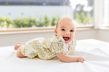 Image showing sweet baby girl lying on white blanket