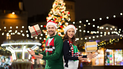 Image showing happy couple with gifts at christmas market