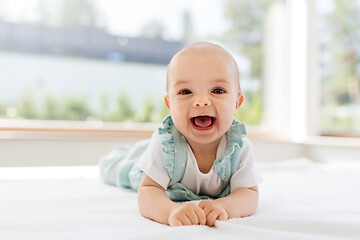 Image showing sweet baby girl lying on white blanket