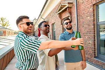 Image showing happy male friends drinking beer at rooftop party