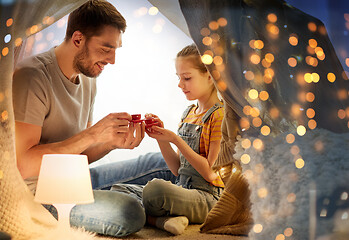 Image showing family playing tea party in kids tent at home