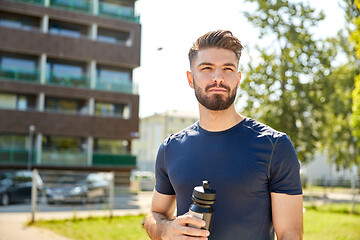 Image showing young sporty man with bottle outdoors