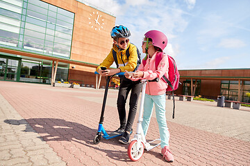 Image showing school children with smartphones and scooters