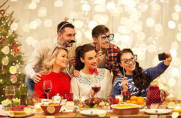 Image showing friends taking selfie at christmas dinner