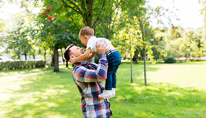 Image showing happy father with son playing in summer park