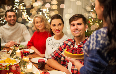 Image showing happy friends having christmas dinner at home