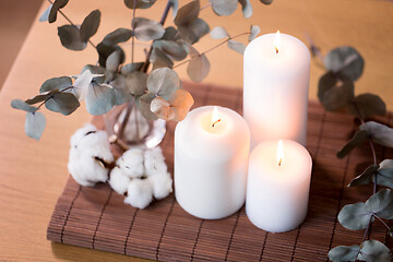 Image showing candles and branches of eucalyptus on table