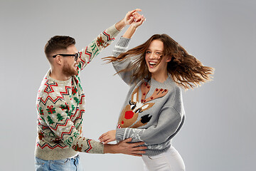 Image showing couple dancing at christmas ugly sweaters party