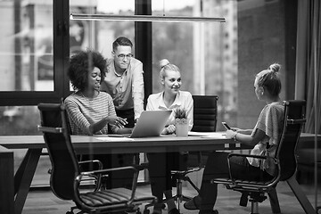 Image showing Multiethnic startup business team in night office