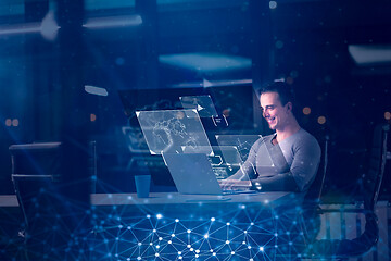 Image showing man working on laptop in dark office