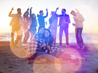 Image showing Couple enjoying with friends at sunset on the beach