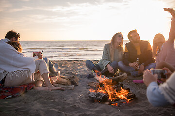 Image showing Friends having fun at beach on autumn day