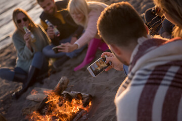 Image showing Friends having fun at beach on autumn day