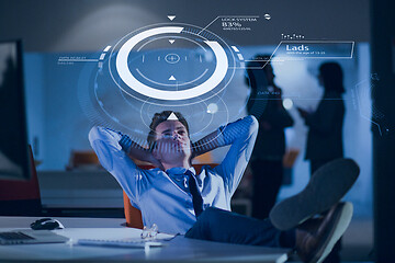 Image showing businessman sitting with legs on desk at office