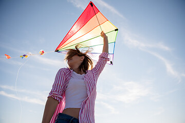 Image showing Young Woman with kite at beach on autumn day