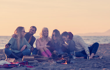 Image showing Friends having fun at beach on autumn day