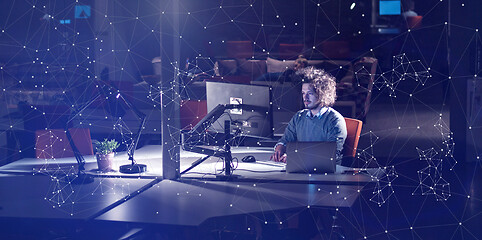 Image showing man working on computer in dark office