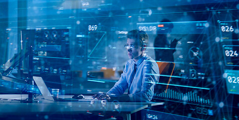 Image showing man working on computer in dark office