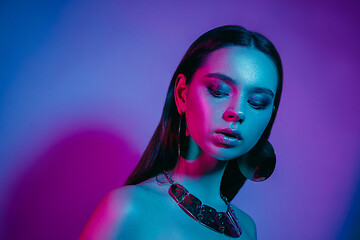 Image showing High Fashion model in colorful bright neon lights posing at studio