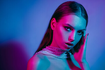 Image showing High Fashion model in colorful bright neon lights posing at studio