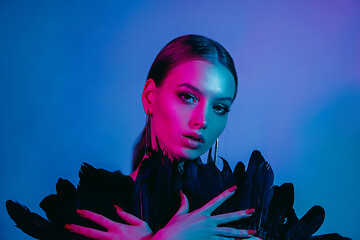 Image showing High Fashion model in colorful bright neon lights posing at studio