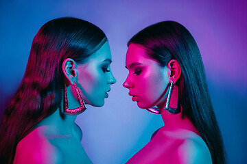 Image showing High Fashion models in colorful bright neon lights posing at studio