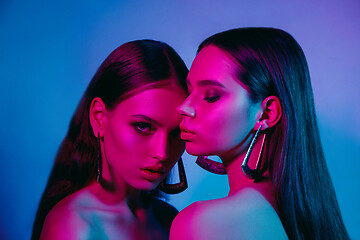 Image showing High Fashion models in colorful bright neon lights posing at studio