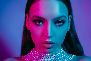 Image showing High Fashion model in colorful bright neon lights posing at studio