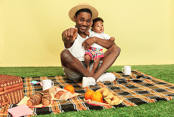 Image showing Happy family having picnic at studio