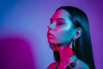 Image showing High Fashion model in colorful bright neon lights posing at studio