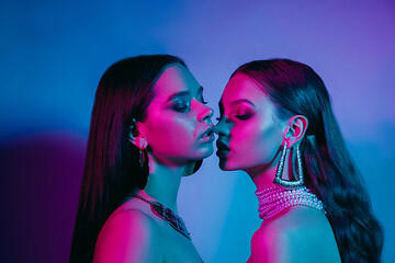 Image showing High Fashion models in colorful bright neon lights posing at studio