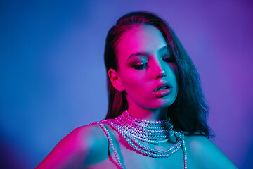 Image showing High Fashion model in colorful bright neon lights posing at studio