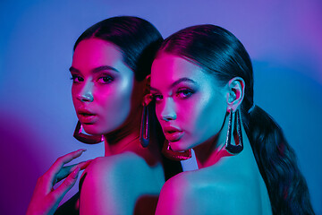 Image showing High Fashion models in colorful bright neon lights posing at studio