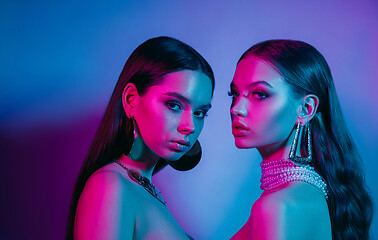 Image showing High Fashion models in colorful bright neon lights posing at studio