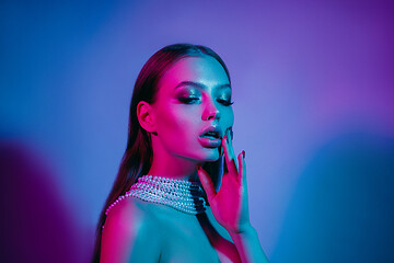 Image showing High Fashion model in colorful bright neon lights posing at studio