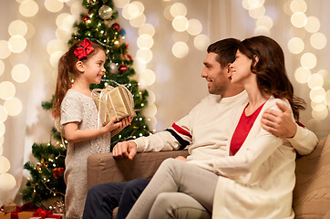 Image showing happy family with christmas present at home