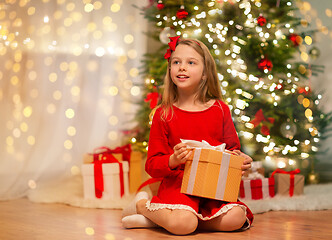 Image showing smiling girl with christmas gift at home