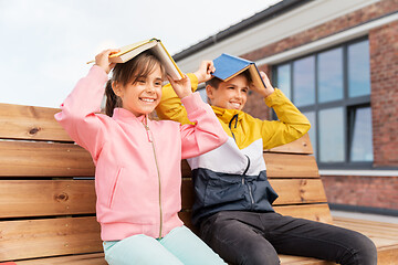 Image showing school children with books having fun outdoors